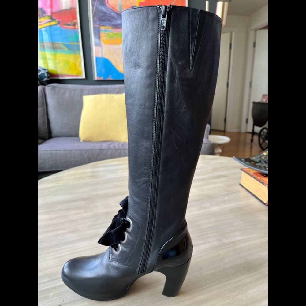 John Fluevog black leather knee high-boots with patent accents.